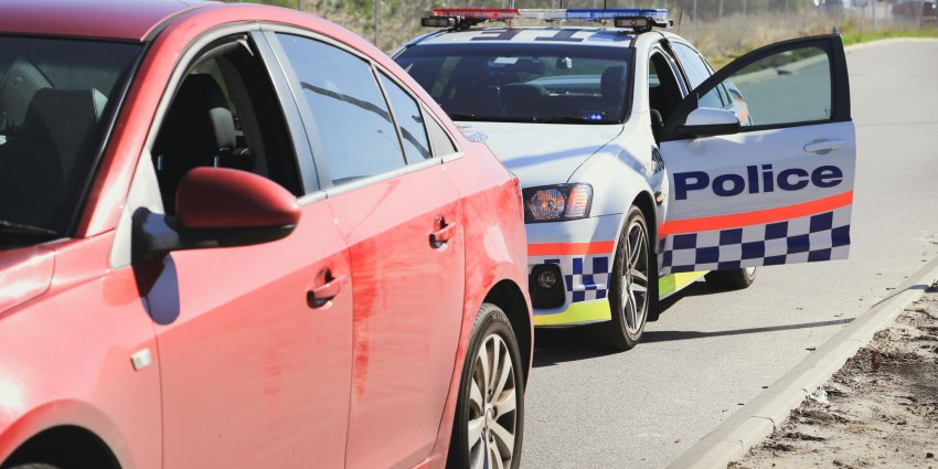 Police car with door open after pulling over a car
