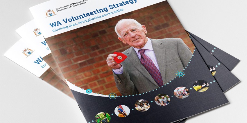 Several copies of the WA Volunteering Strategy on a bench top.