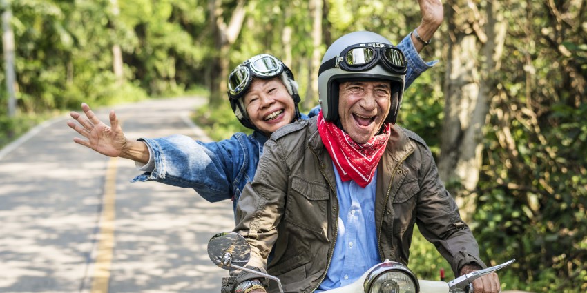 Happy senior couple on scooter