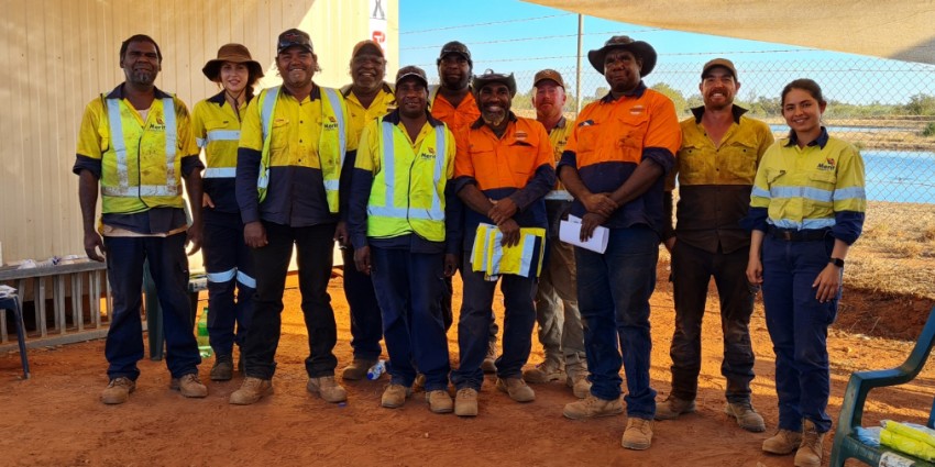Group photo of the Bayulu remediation project team, including community workers and MCG representatives.
