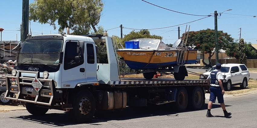 small boat on the back of a truck