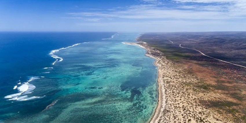 Aerial shot of flat coast and shallow water