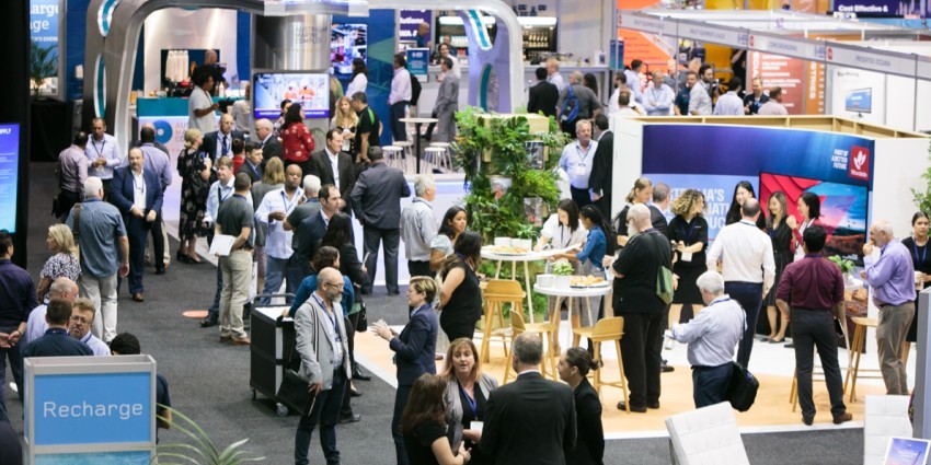 Attendees network on the exhibition floor at an AOG Energy conference