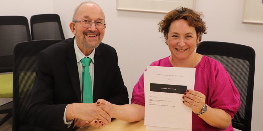 Dr Byrne and Ms Cokis shaking hands with signed MoU