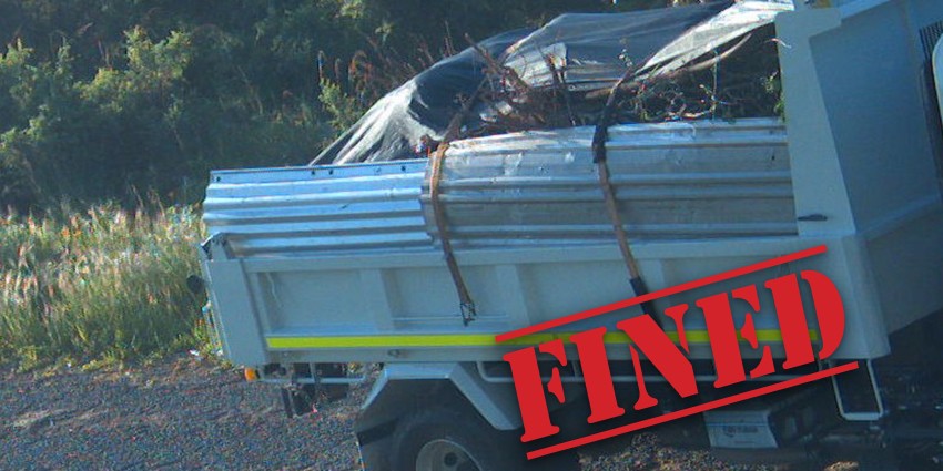 Photo of a tip truck used to illegally dump waste, including sheets of tin and tree roots