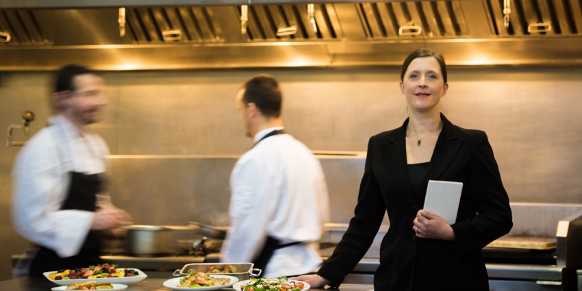 image of a woman and two men working in a restaurant