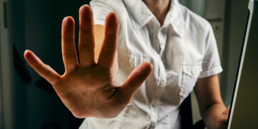 Woman with her hand outstretched making a 'no' gesture