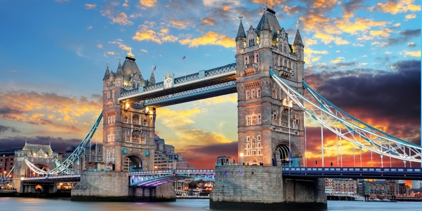 Tower Bridge in London at sunset with lit up buildings in the background