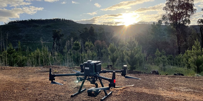 Large drone on gravel track with sunset in background