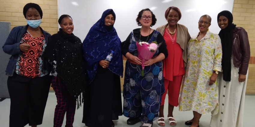 A group photo of seven women - 2022 grant recipient Silver Lining Fashion Fund Inc. - African Women's Safety and Justice Counselling Workshop