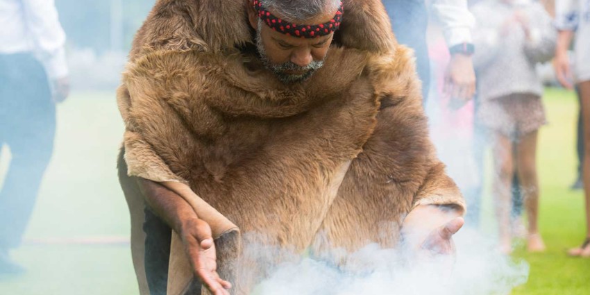 An Aboriginal man performing a smoking ceremony