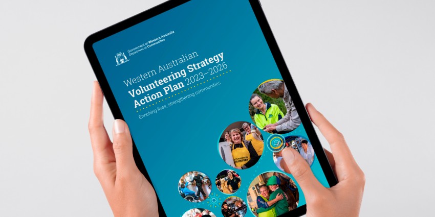 image of a person holding a tablet computer with the volunteering action plan from page on the screen