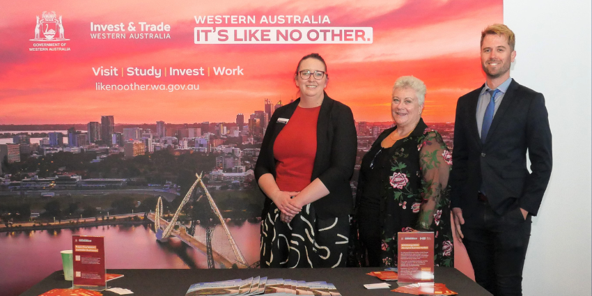 Three representatives standing behind a booth at the indigenous Emerging Businesses Forum 