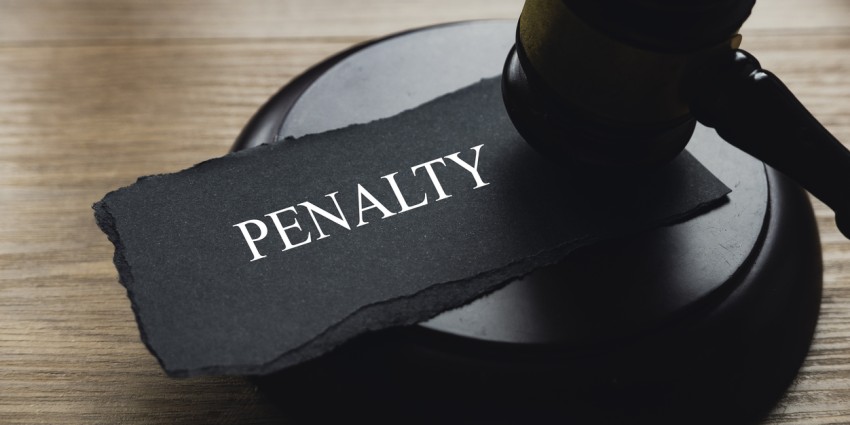 photo of a large stamp with the word 'penalty' marked on it