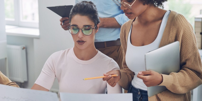 Image of two professional women looking at documents