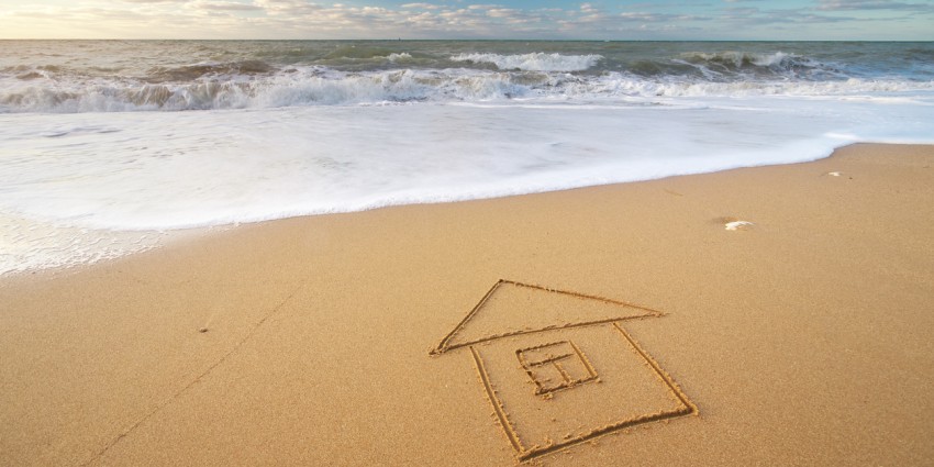 Nature composition of a beach with a house drawn in the sand