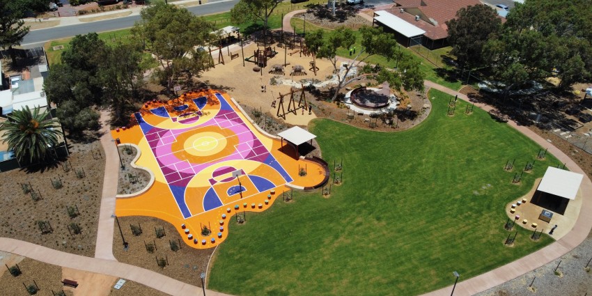aerial photo of community parklands with playgrounds and basketball courts