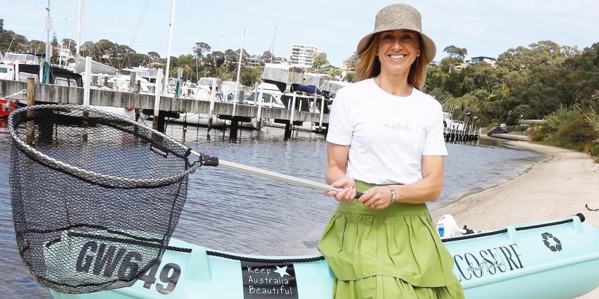 lady standing next to dinghy on swan river