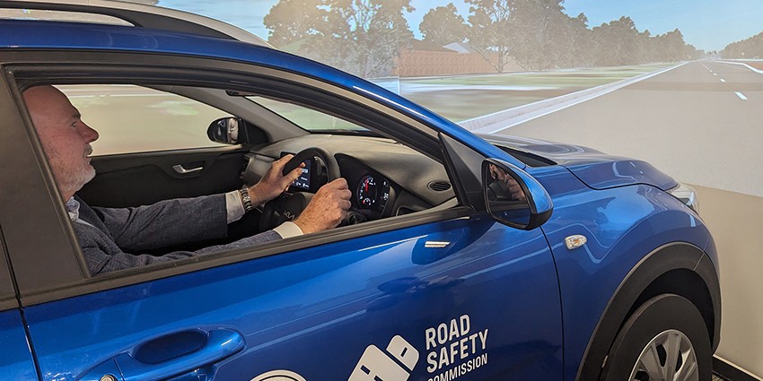 Road Safety Commissioner Adrian Warner test drives the new simulator