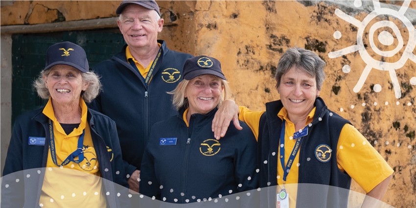 photo of a group of middle aged smiling volunteers 