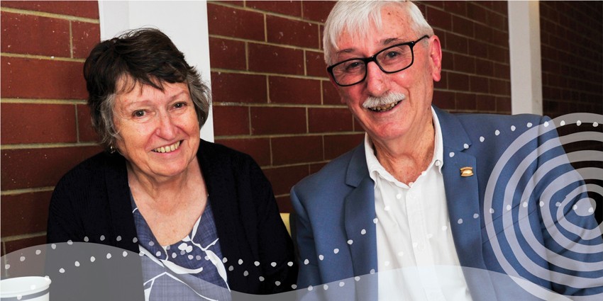 Photo of an elderly man and woman well dressed and smiling