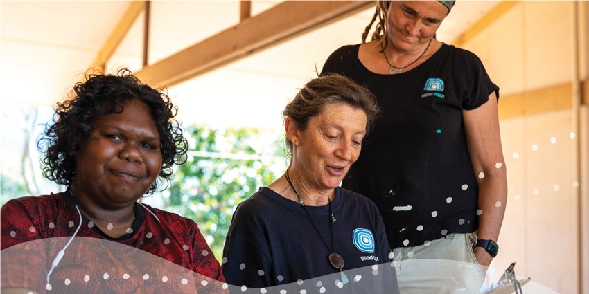Photo of three women who are volunteers in an indoor setting