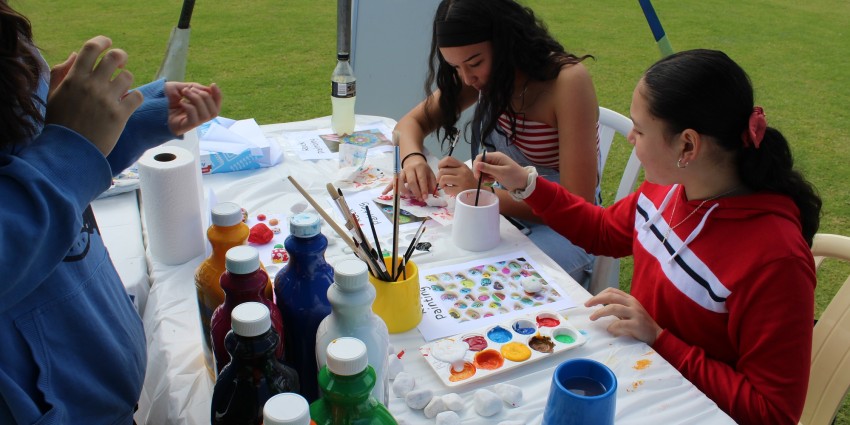 Photo of a group of young people engaged in a painting activity