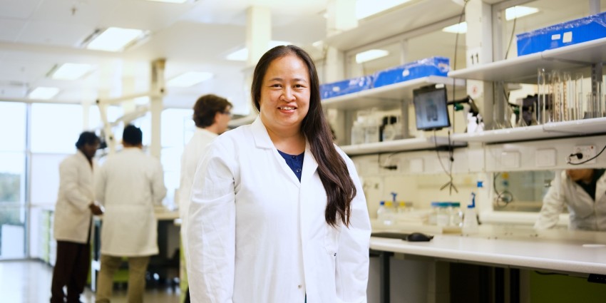 Alexandra Yeoung smiling as she works in a lab