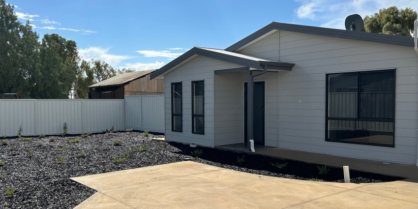 A picture of the front of a newly built house.