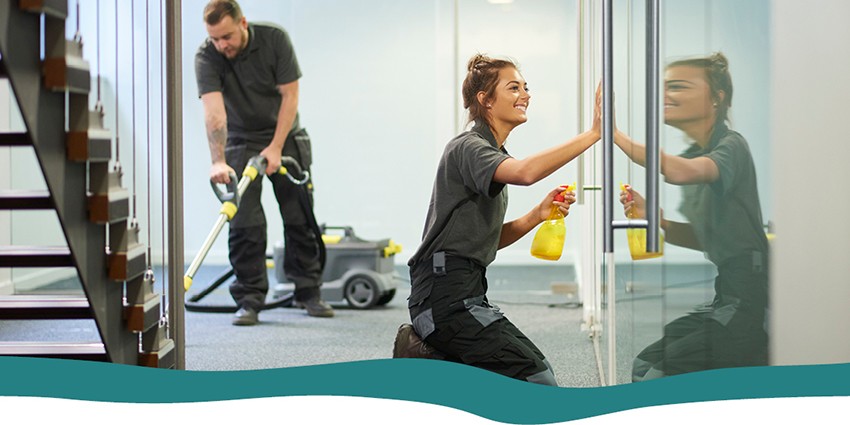 Two professional cleaners cleaning an office 