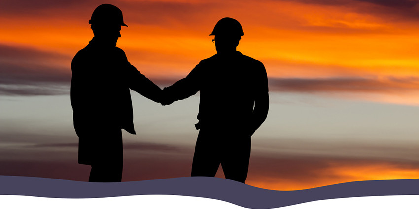 sunset with two people wearing hard hats