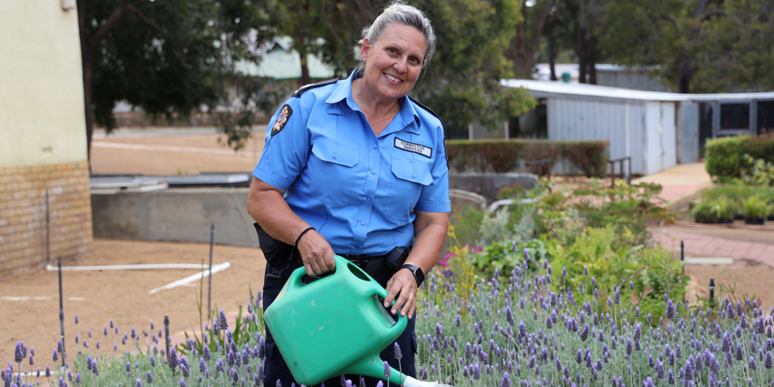 Vocational Support Officer watering plants