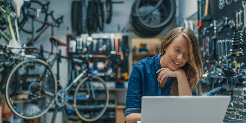 Bike shop with owner looking at her laptop screen