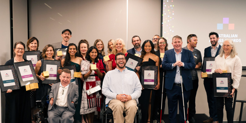a group of differently abled people celebrating and holding awards