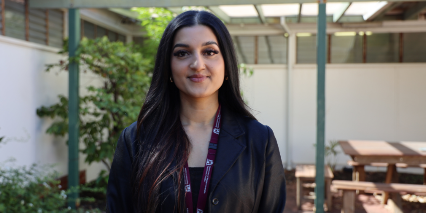 Aishwarya - Youth Justice Officer standing in an open staff lunch area