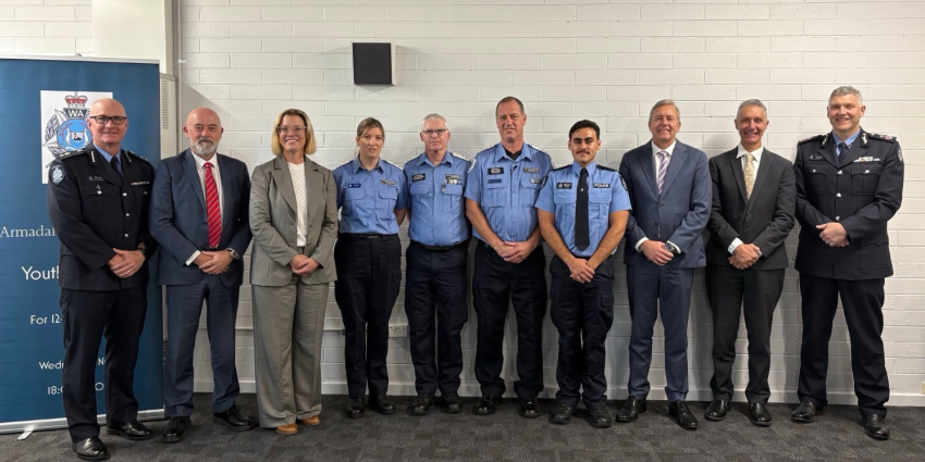 A group photo of 8 people - the award winners, police and ministers