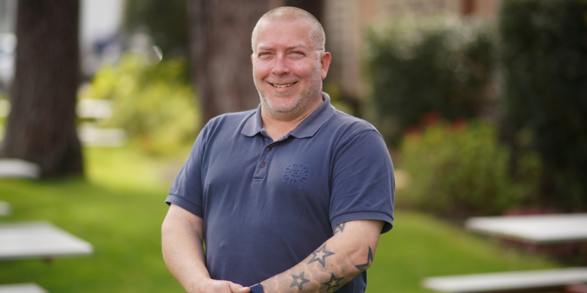 Colin - Youth Justice Officer standing outside the office in an open area