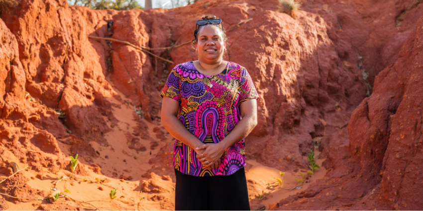 Jasmine - Youth Justice Officer standing in from of a rocky area