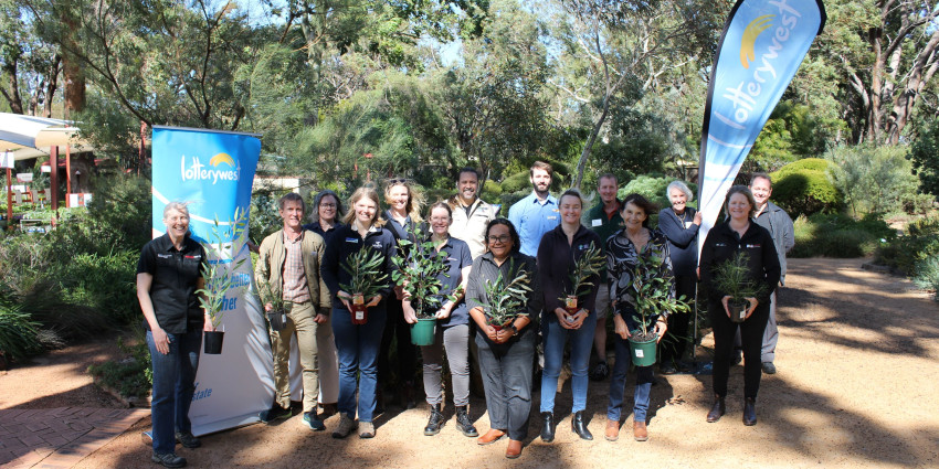 psa finalist keep carnaby flying ngoolarks forever team standing together holding plants 