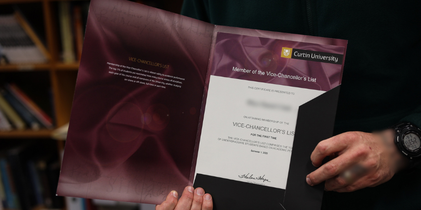 A person holding a certificate of achievement - Vice Chancellor’s List