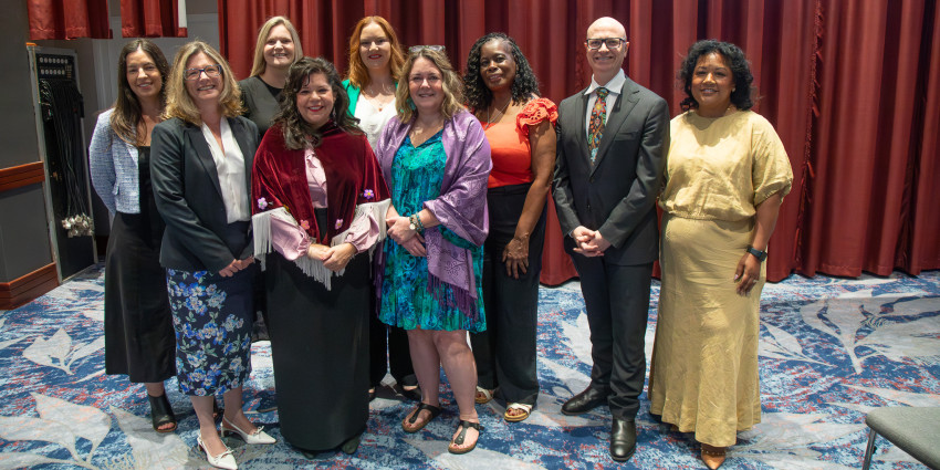 a group of representatives on stage together during the Signs of Safety Gathering