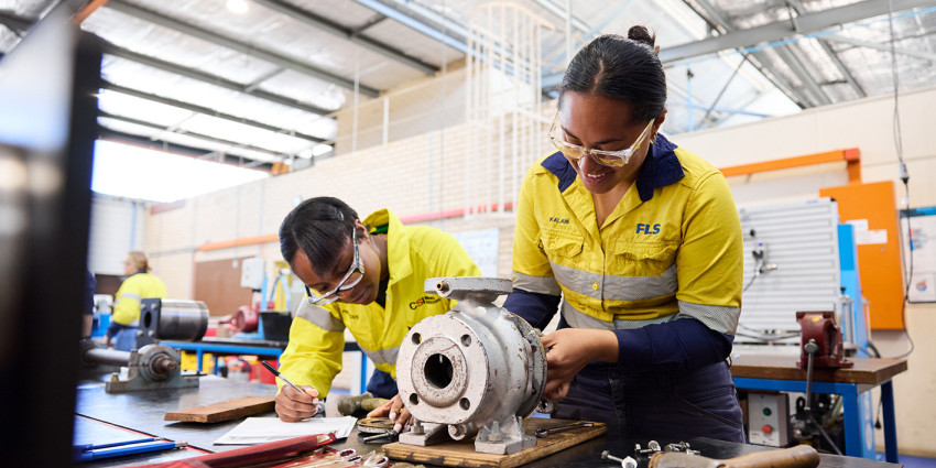 two women working in trades with tools