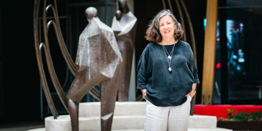 A middle age well dressed women, Caron Irwin, pictured out front of Communities head office building