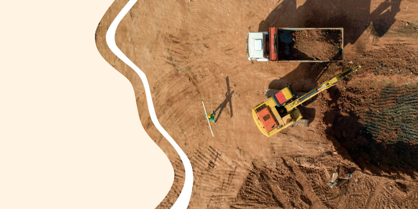 overhead photo of a dump trick and excavator digging 