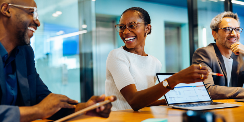 People laughing and smiling in a meeting