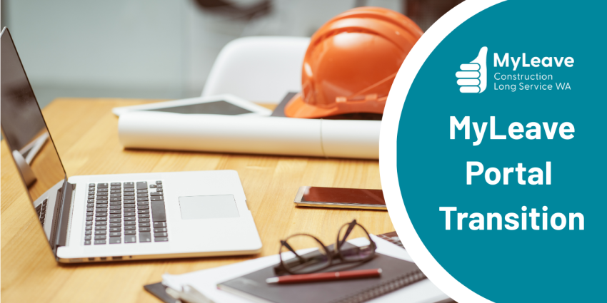 Laptop on construction desk, hard hat