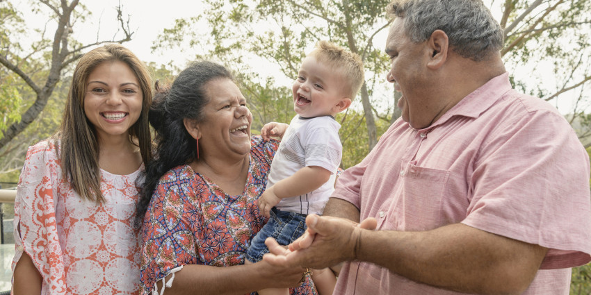 Three generation Aboriginal family, smiling, baby, young adult, middle age man, older woman