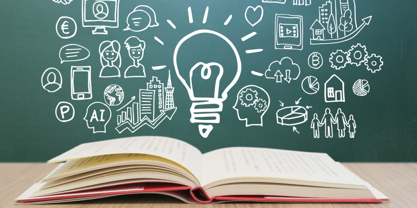 a book on a table with a visual illustration above the book of ideas and light-bulb moments