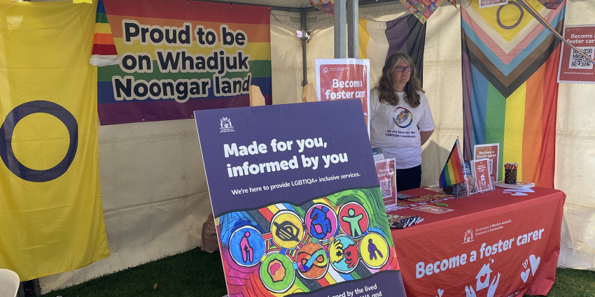 The Department of Communities LGBTIQA+ stall with colourful banners and information