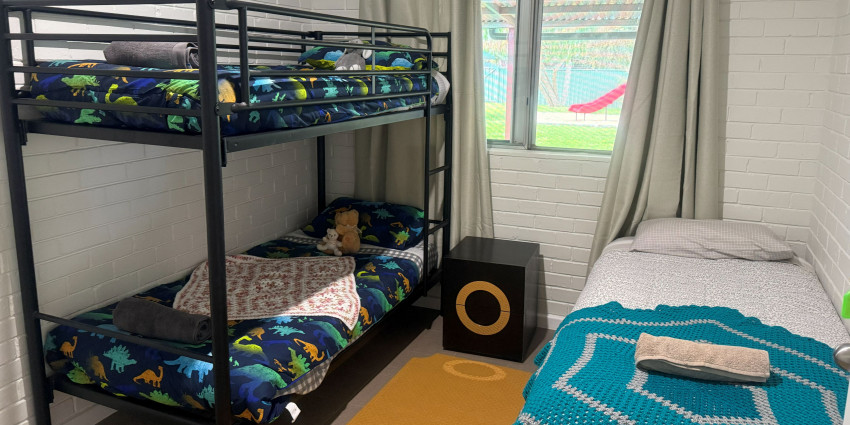 a children's bedroom with a twin bunk bed and a single bed